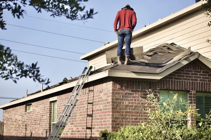 Professional roofer working on a residential roof in Brice